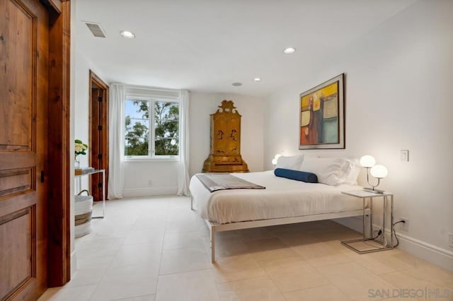 bedroom with light tile patterned floors