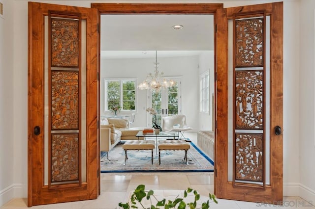 interior space featuring a notable chandelier and light tile patterned flooring