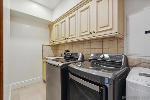 washroom with cabinets and separate washer and dryer