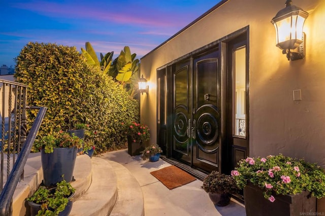 exterior entry at dusk with a patio area