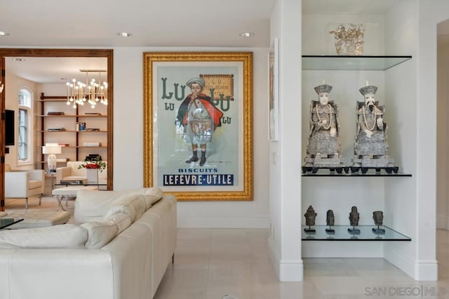 tiled living room featuring a notable chandelier