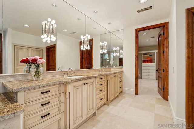 bathroom with vanity and an inviting chandelier