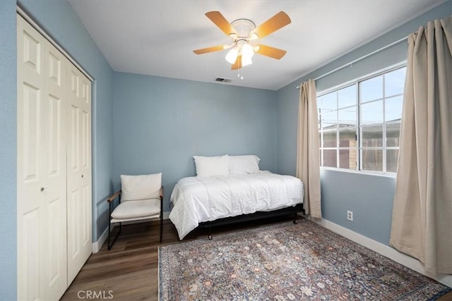 bedroom featuring hardwood / wood-style flooring, ceiling fan, and a closet