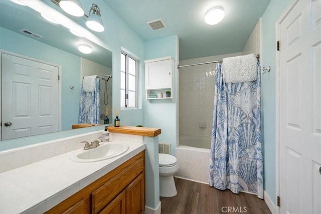 full bathroom featuring vanity, toilet, hardwood / wood-style floors, and shower / bath combo with shower curtain