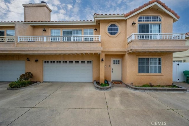 view of front of house featuring a garage and a balcony