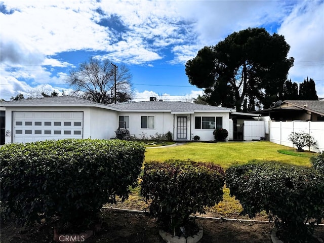 ranch-style house with a garage and a front lawn