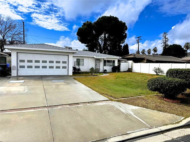 single story home featuring a garage and a front yard