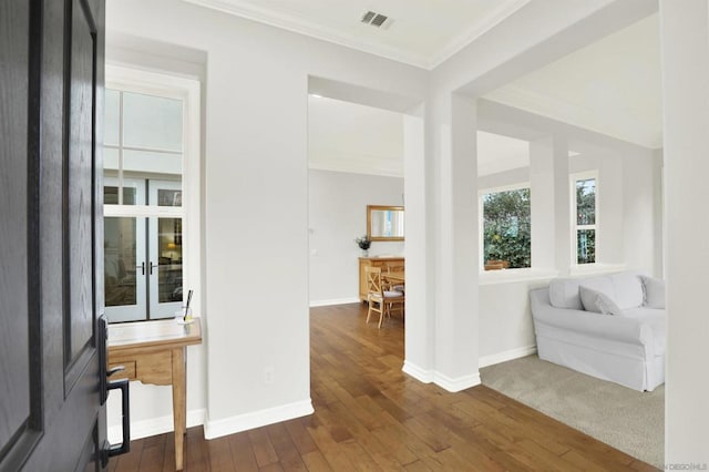 interior space with dark wood-type flooring and ornamental molding