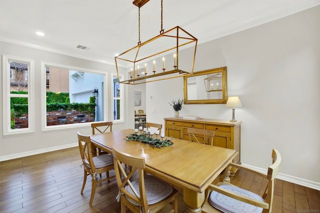 dining room featuring ornamental molding and dark hardwood / wood-style floors