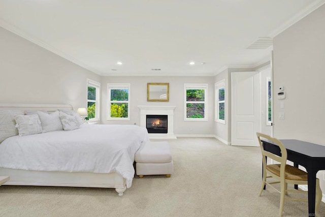 bedroom with ornamental molding and light colored carpet