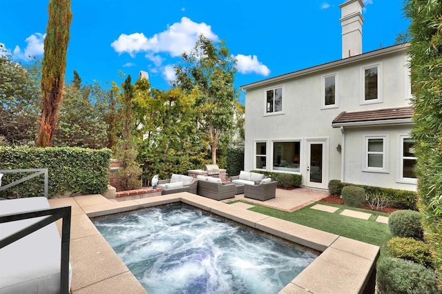 rear view of house with an outdoor living space and a patio