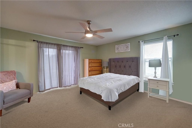 bedroom with ceiling fan and carpet floors