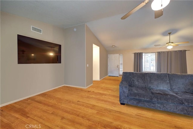 living room featuring ceiling fan, lofted ceiling, and light hardwood / wood-style floors