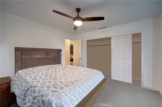 carpeted bedroom featuring a closet and ceiling fan