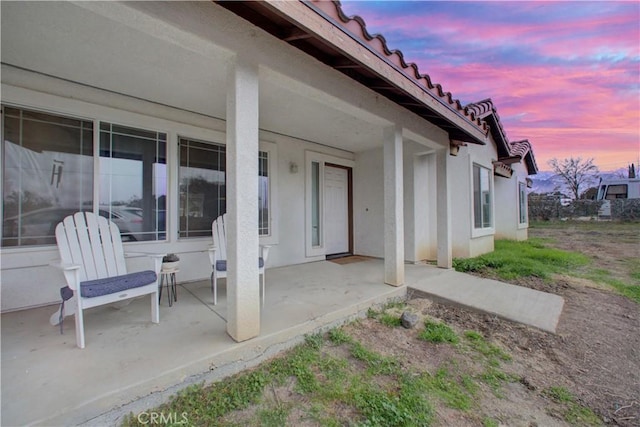 view of patio terrace at dusk