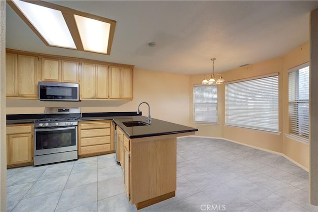 kitchen with sink, appliances with stainless steel finishes, light brown cabinets, light tile patterned flooring, and pendant lighting