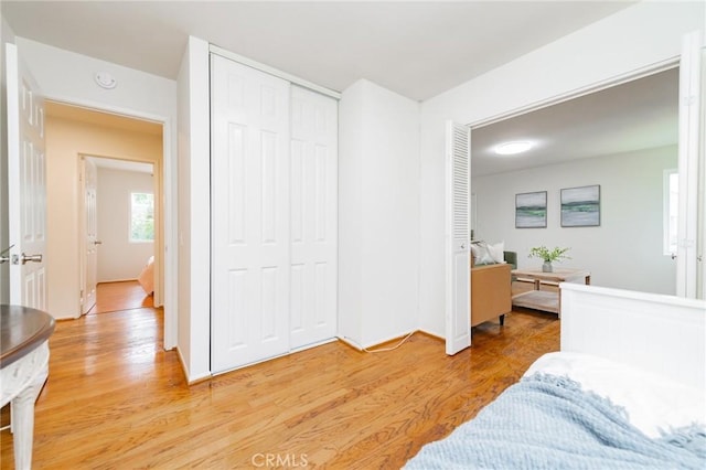 bedroom with hardwood / wood-style floors and a closet