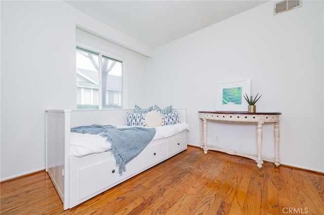 bedroom with wood-type flooring