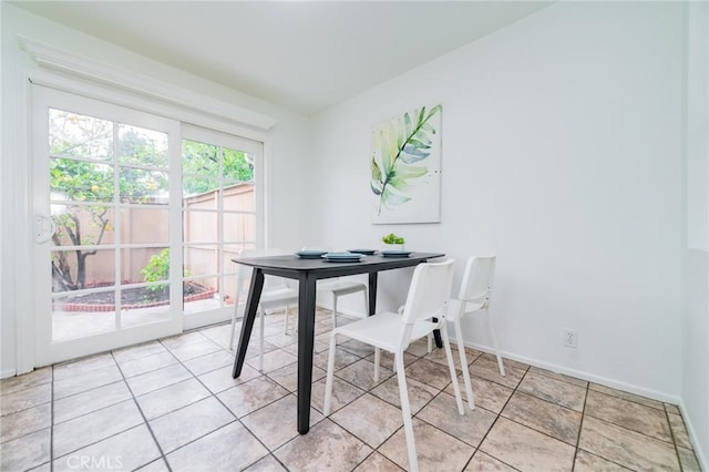 dining area featuring light tile patterned floors