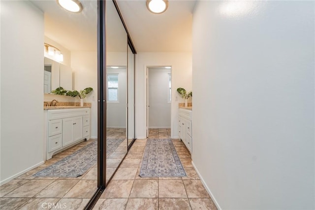 bathroom with tile patterned floors and vanity