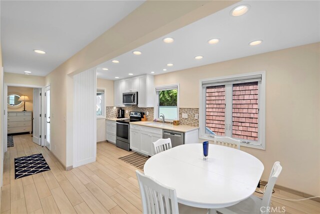 1051 Gaviota Dr, Laguna Beach, CA 92651 - kitchen featuring stainless steel appliances, light countertops, tasteful backsplash, white cabinetry, and recessed lighting