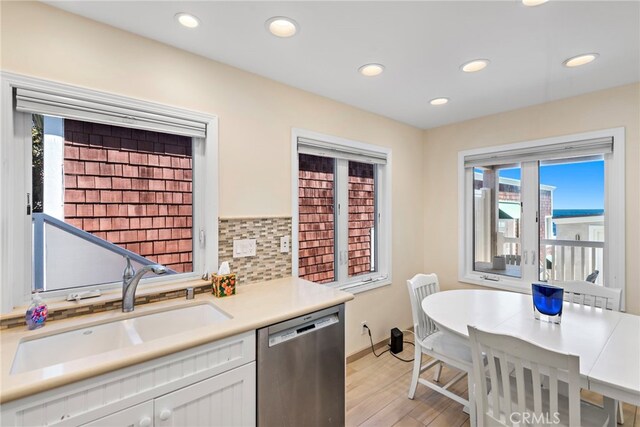 1051 Gaviota Dr, Laguna Beach, CA 92651 - kitchen with stainless steel dishwasher, light wood finished floors, white cabinetry, recessed lighting, and light countertops