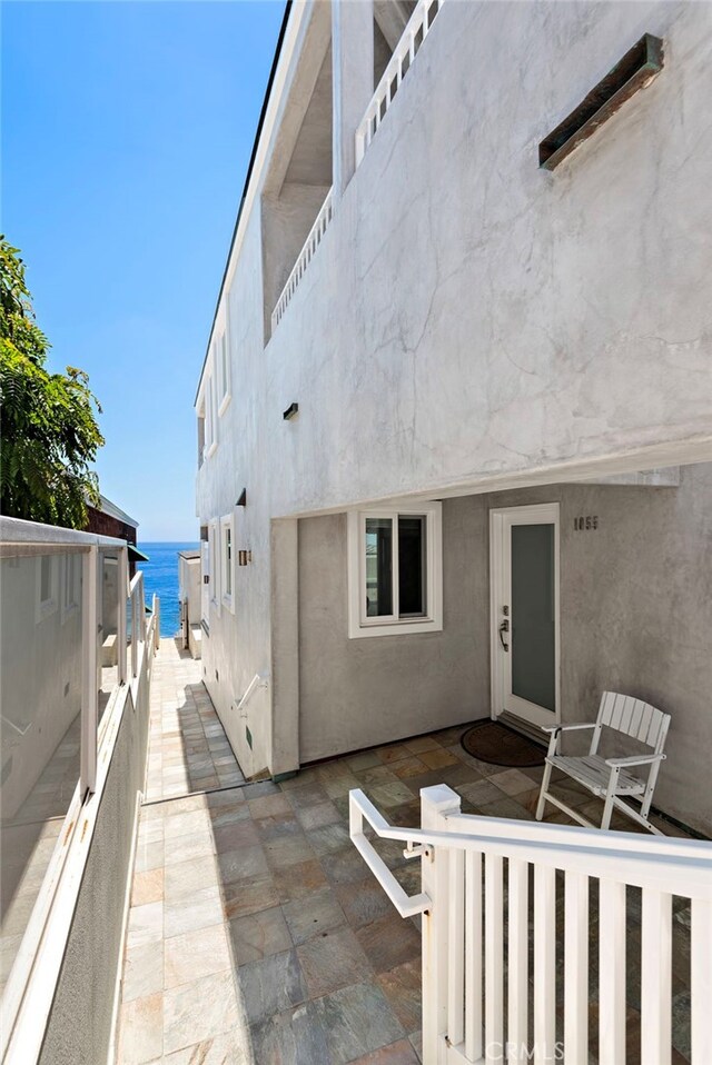 1051 Gaviota Dr, Laguna Beach, CA 92651 - back of property with stucco siding, a water view, and a patio