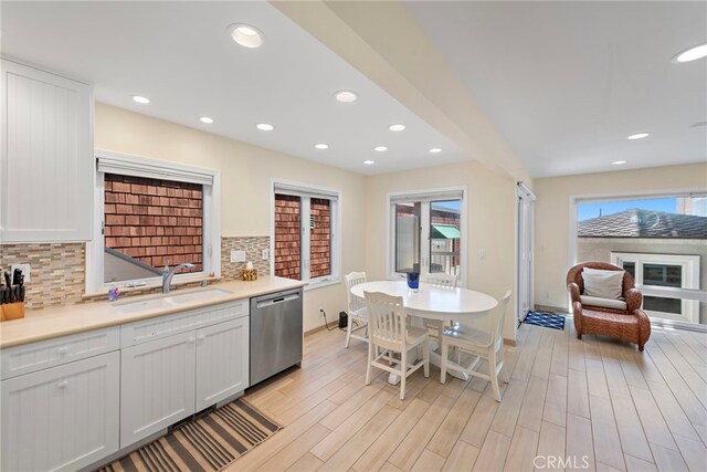 1051 Gaviota Dr, Laguna Beach, CA 92651 - kitchen featuring stainless steel dishwasher, tasteful backsplash, light countertops, light wood finished floors, and recessed lighting
