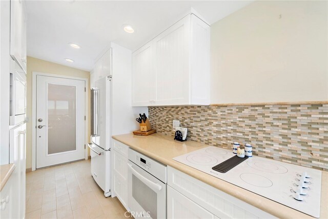 1051 Gaviota Dr, Laguna Beach, CA 92651 - kitchen featuring white appliances, white cabinets, decorative backsplash, light countertops, and recessed lighting