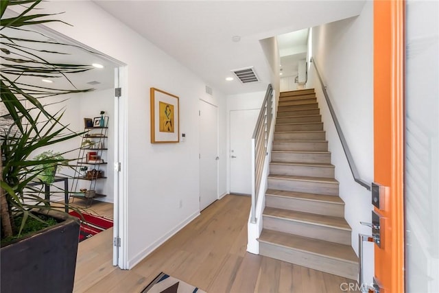 staircase featuring hardwood / wood-style floors