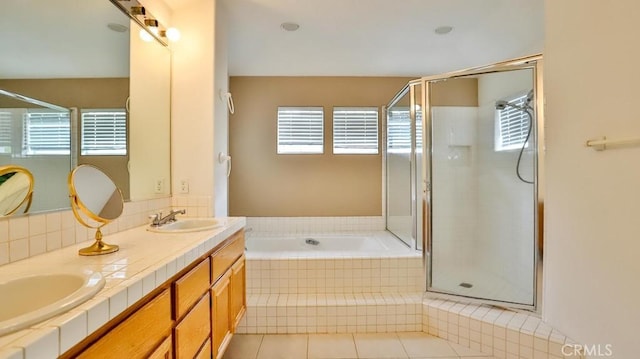 bathroom featuring tasteful backsplash, vanity, independent shower and bath, and tile patterned flooring