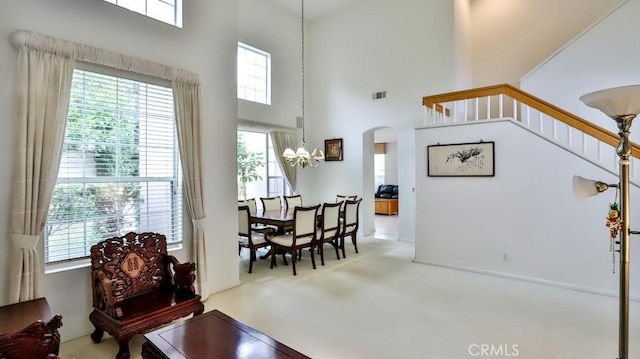 interior space with a high ceiling and a chandelier