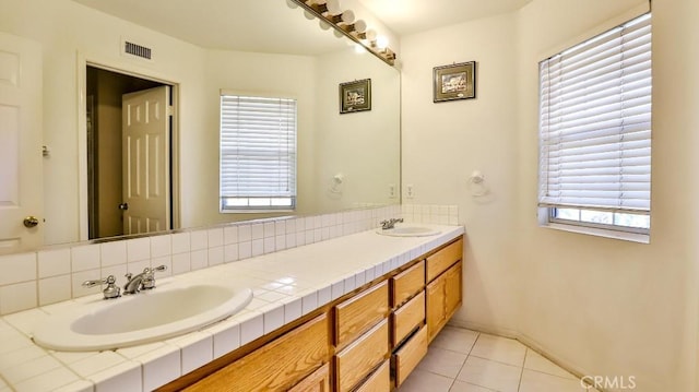 bathroom with vanity, plenty of natural light, and tile patterned floors