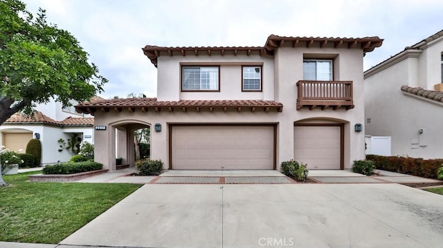 mediterranean / spanish house featuring a garage, a balcony, and a front lawn