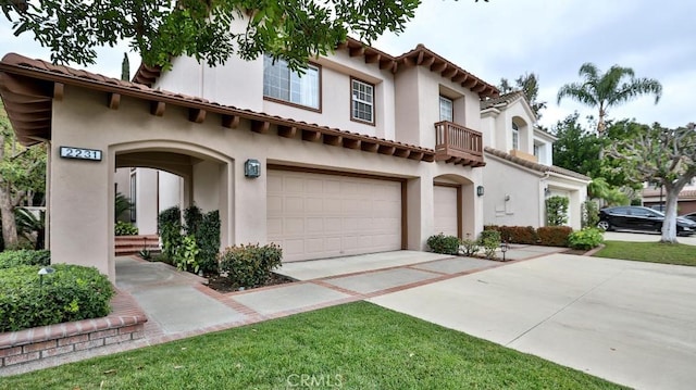 mediterranean / spanish-style home with a garage