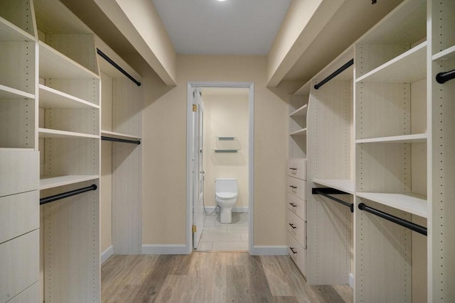 spacious closet with light hardwood / wood-style floors