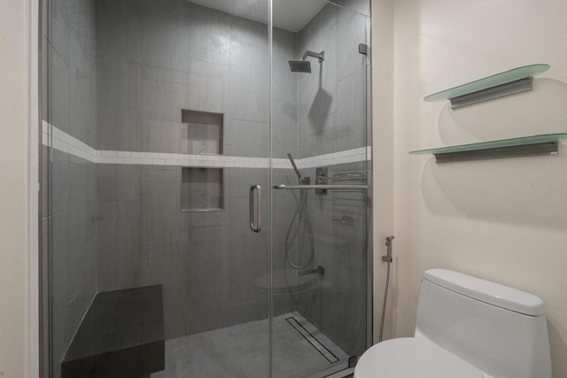 bathroom with walk in shower and toilet