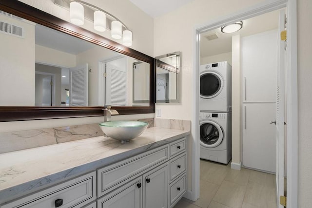 bathroom with stacked washer and dryer and vanity