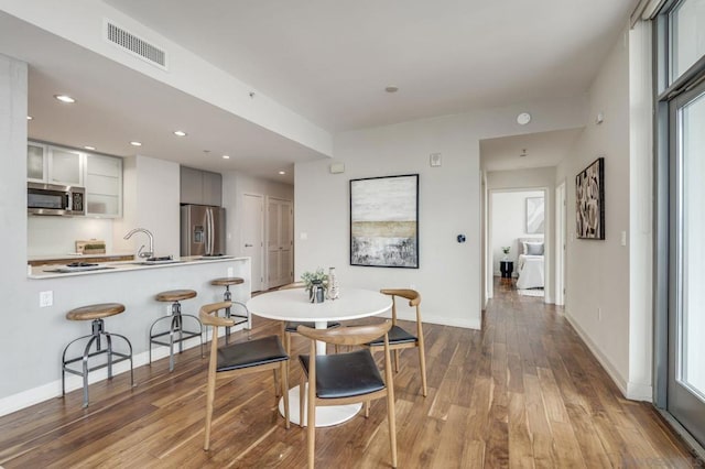 dining room with hardwood / wood-style flooring