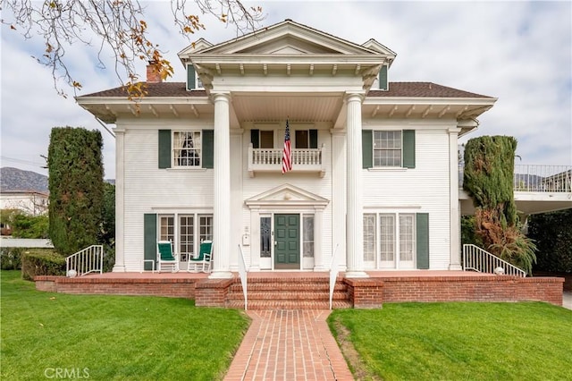 rear view of property with a yard