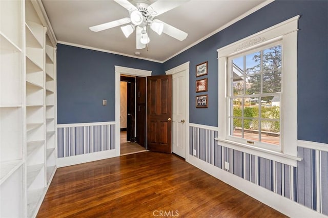 unfurnished room featuring ceiling fan, ornamental molding, and dark hardwood / wood-style flooring