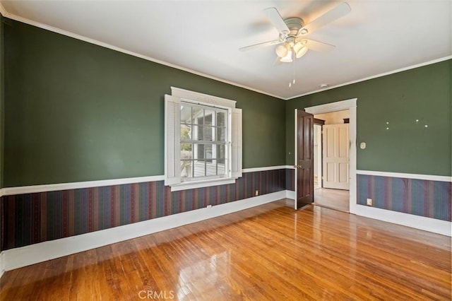 spare room featuring hardwood / wood-style flooring, ceiling fan, and ornamental molding