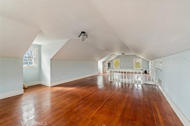 bonus room with lofted ceiling and hardwood / wood-style floors