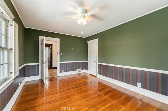 unfurnished room featuring crown molding, ceiling fan, and wood-type flooring