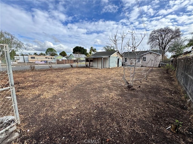 view of yard featuring an outbuilding and fence