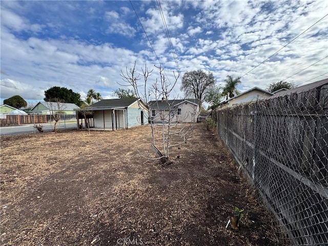 view of yard with an outbuilding and fence