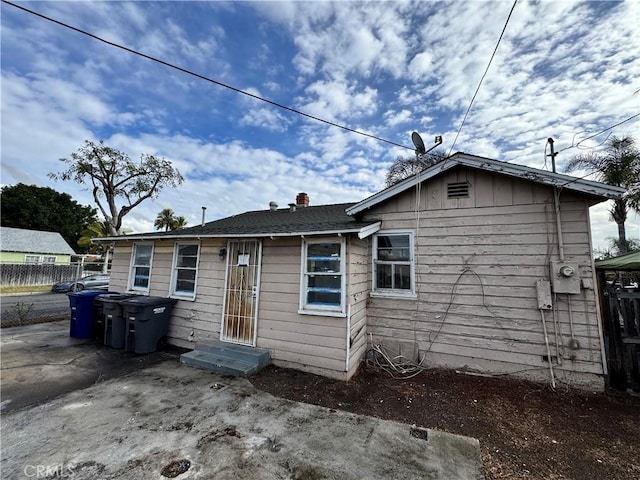 back of house featuring fence