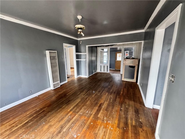 unfurnished living room featuring crown molding and dark hardwood / wood-style flooring