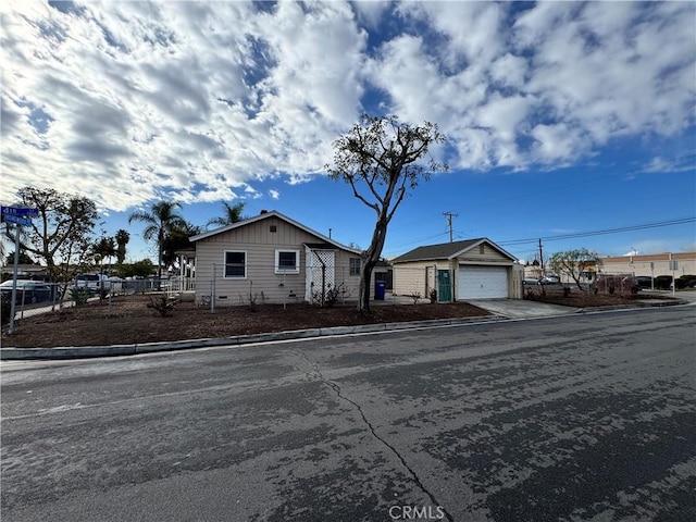 view of front of house with a garage and an outdoor structure