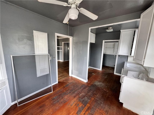 interior space with ceiling fan and dark hardwood / wood-style flooring